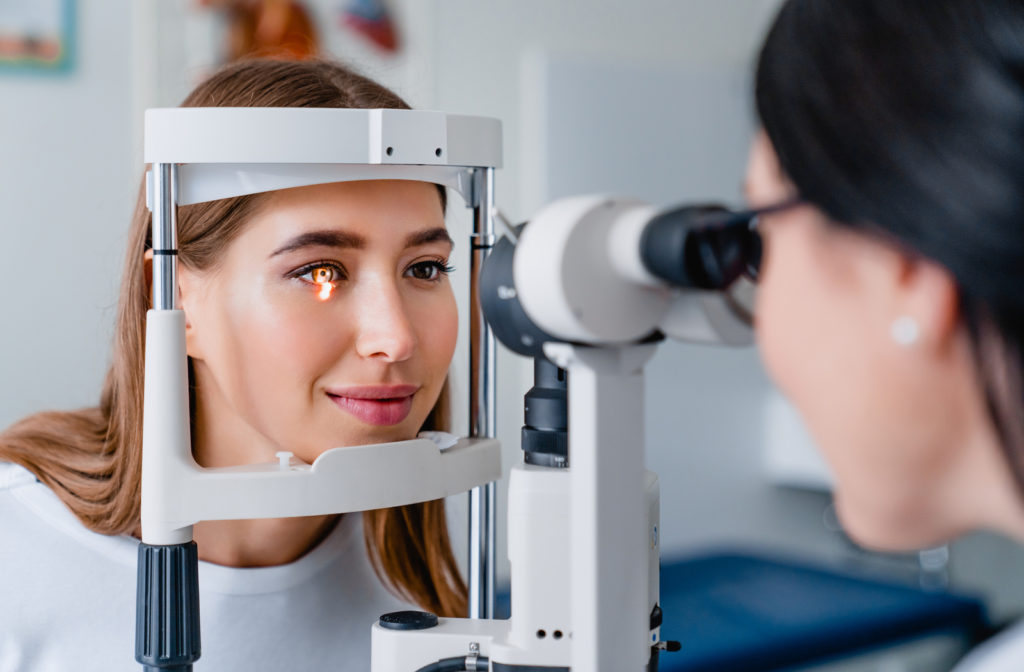 Young woman getting eye exam from her optometrist