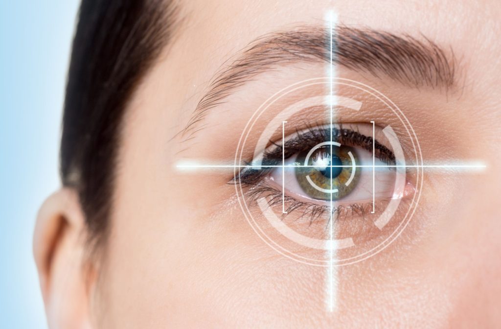 Close-up of a woman’s green eye with a light blue laser scanner making a grid over the centre of her eye