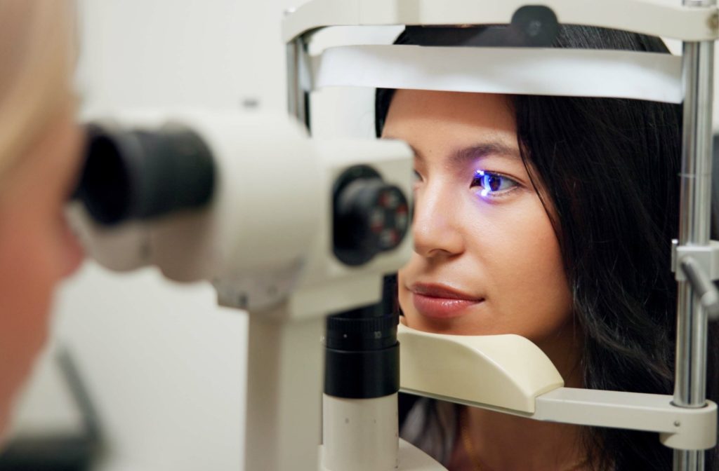 A young woman undergoes an eye exam.