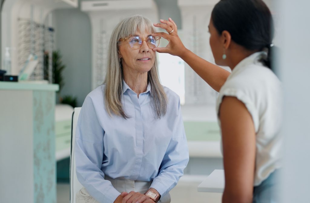 A glasses wearer getting fitted for their new glasses by their optician