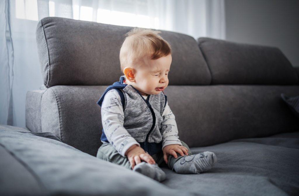 Toddler showing signs of discomfort due to eye allergies.