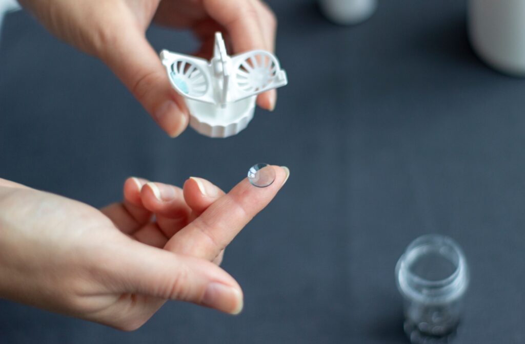 Close-up image of an Ortho-K lense balancing on the tip of someone's finger