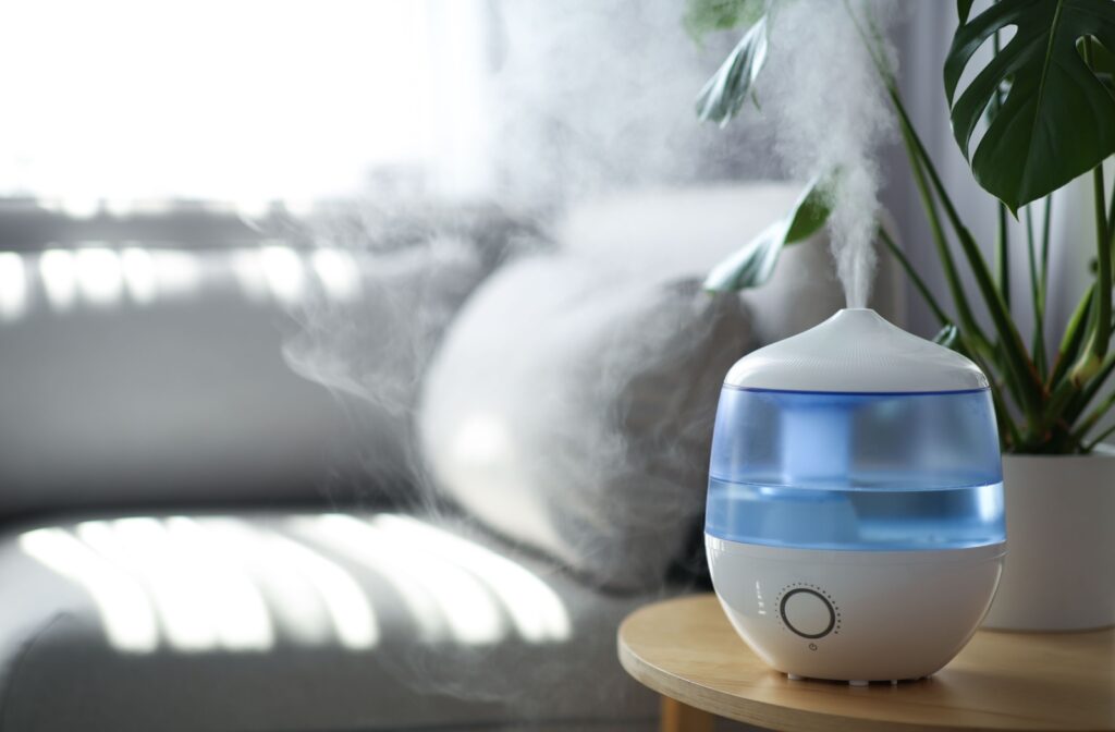 A humidifier sitting on a table in a living room to help add moisture to the air and minimize dry eye symptoms from menopause